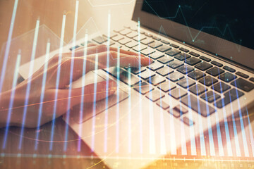 Double exposure of woman hands typing on computer and forex chart hologram drawing. Stock market analysis concept.
