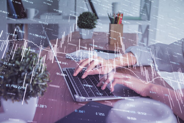 Double exposure of woman hands typing on computer and forex chart hologram drawing. Stock market...