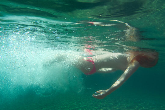 woman floating underwater