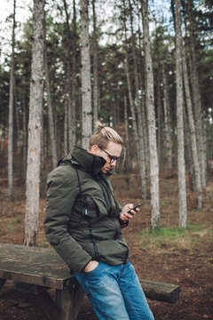 Man with cell phone in the forest
