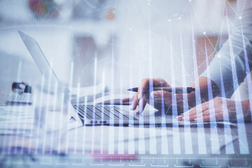 Double exposure of woman hands typing on computer and forex chart hologram drawing. Stock market invest concept.