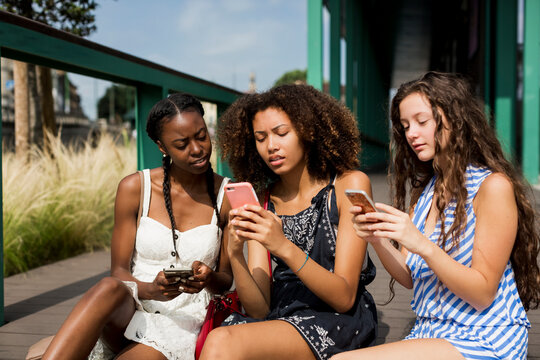 Three women addicted to mobile phones