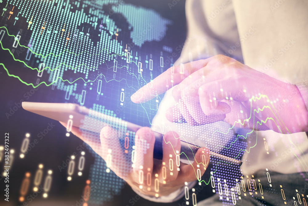 Poster double exposure of man's hands holding and using a digital device and forex graph drawing. financial