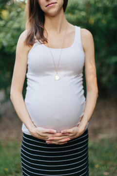 Pregnant woman holding her big belly