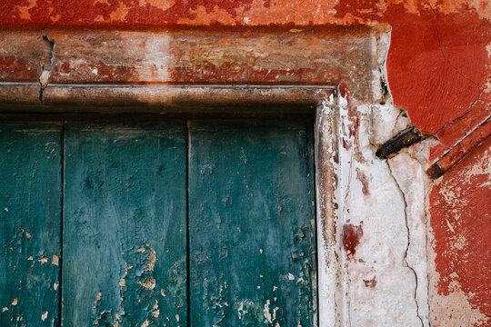 Brightly colored worn paint on a door in Venice, Italy