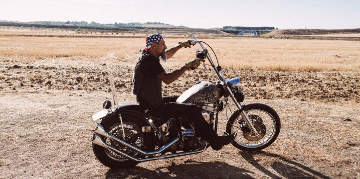Tattooed motorcyclist aged man