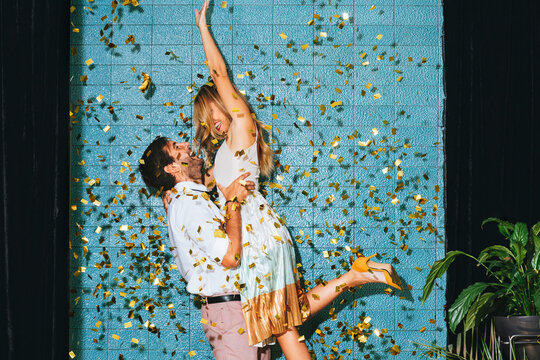 Couple Having Fun Under Confetti