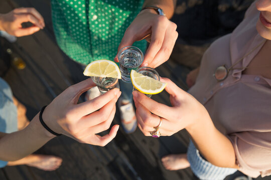 Group of friends drinking tequila shots together
