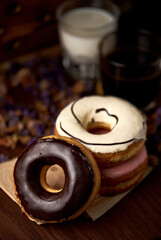 The sweet glazed donuts stacked on the table