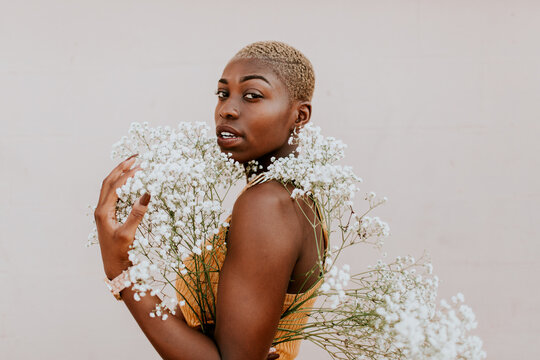 Beautiful african american woman with bouquet of gypsophila