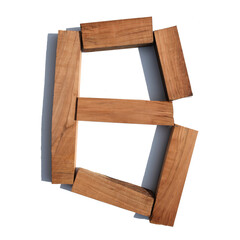 The letter B made of wood blocks on a white background board