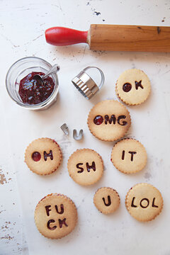 Shortbread biscuits / cookies filled with jam and buttercream spelling swear words