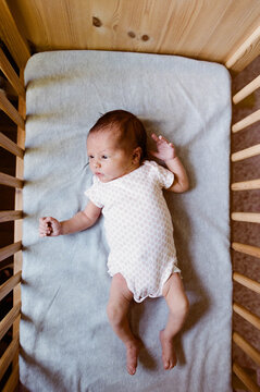 newborn baby in bassinet crib