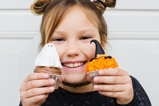 Little girl and Halloween cupcake