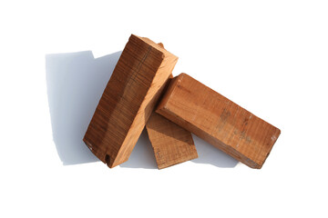 Three pieces of wood on a white background board