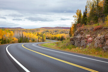 Curving highway and colorful trees in northern Minnesota on a autumn day