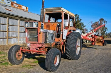 Fototapeta premium An Old Rundown Tractor with Auger Attached