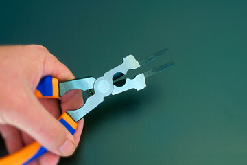 Hand holds a multifunction pliers