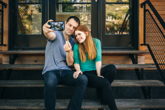 Couple taking a selfie with key to new house
