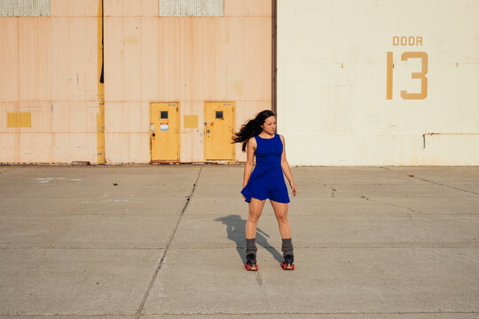 Woman on roller skates watching something in the distance