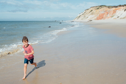 boy running by the waves in Martha's Vineyard