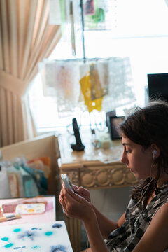 Teenager girl listening to music and typing on her cellphone