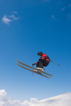 Skier jumping on a snow kicker on the slope