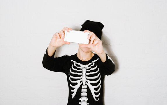 Young woman taking a selfie on halloween