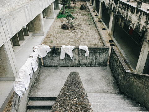 White Kimonos Drying Outdoors on Cement Staircase