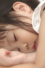 Fototapeta na wymiar little girl sleeping on the bed