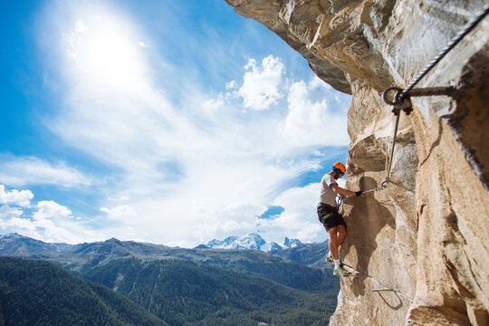 Man climbing via ferrata above Zermatt