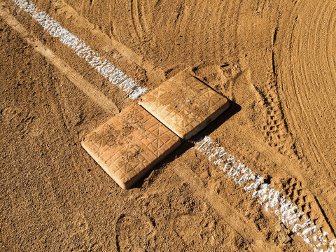 Detail of first base and freshly painted boundary line on baseball field