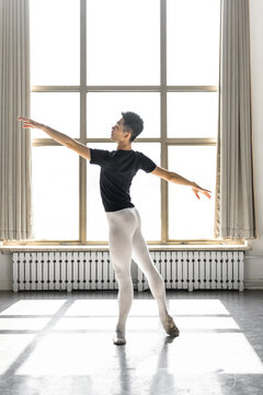 Young professional male dancer practicing in a studio
