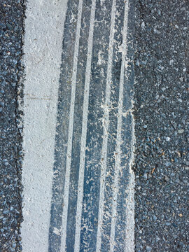 Close of tire tracks on speed bump along urban street