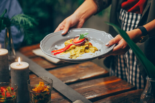 Woman Serving A Meal