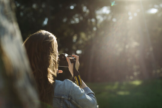 Woman takes a photo with vintage camera
