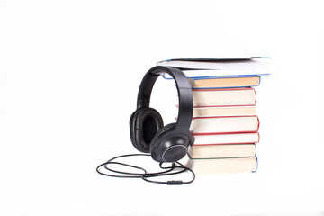 headphones and books on white background