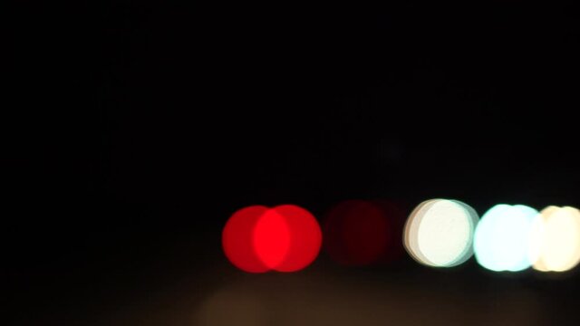 Colorful bokeh lights through car window