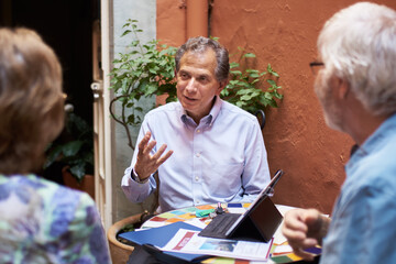 Professional and friendly real estate agent talking to clients