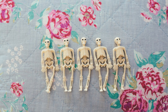 Little skeletons on floral background
