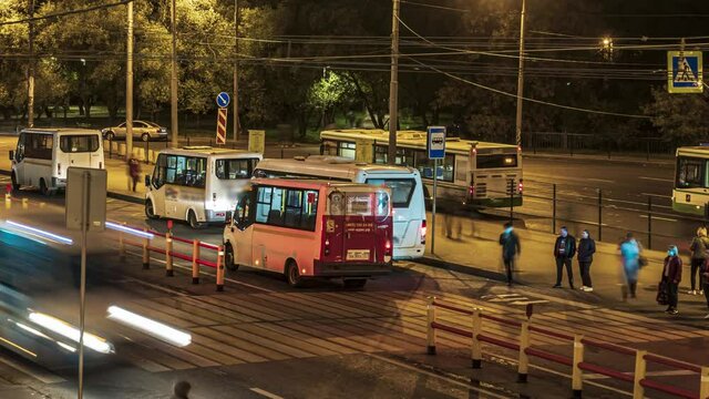Passengers waiting and boarding buses at the bus terminal, time lapse