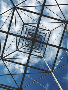 Low angle view of utility tower and cables
