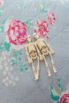Little skeletons on floral background