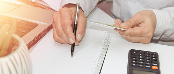 Women's hands using a credit card for payments, taxes, and payments at their workplace. Payment credit card for business