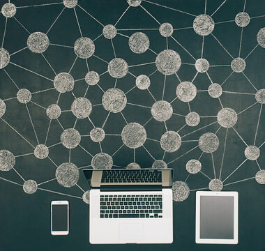 Computer, phone and tablet connected at network illustration on chalkboard