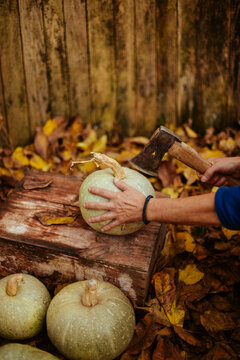 cutting pumpkin with an axe