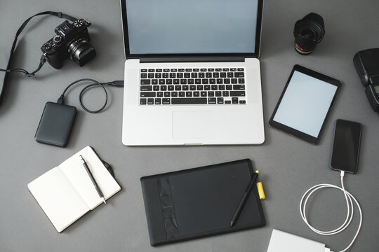 Laptop And Photography Gear On The Grey Background