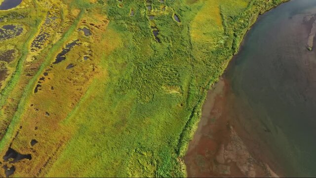 Aerial top view of Avacha river delta and hilly landscape, Kamchatka Peninsula, Russia, 4k