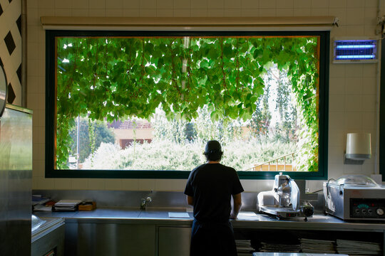 Lonely chef in his big kitchen at the begining of a long workday