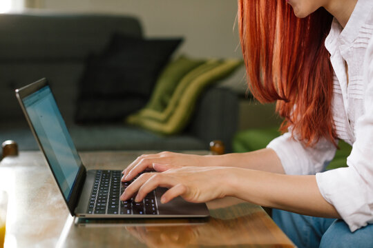 Close up of Young Woman Working on Laptop at her Home